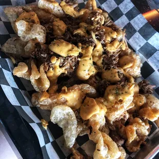 Pork Rind Nachos! Using beer cheese and pulled pork.