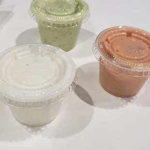 a variety of sauces in plastic containers