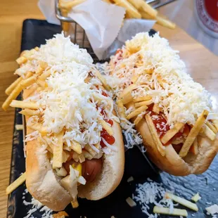 Venezuelan Hot Dogs. $6.99. Two hot dogs topped with coleslaw corn salad, onions, potato sticks, white cheese, mayo, ketchup, mustard, +.