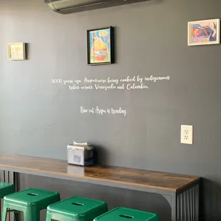 a bar with green stools