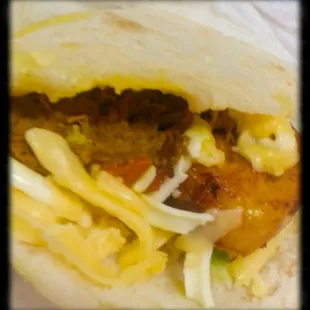 Arepa with shredded beef, yellow and white cheese, sweet plantains and avocado and egg