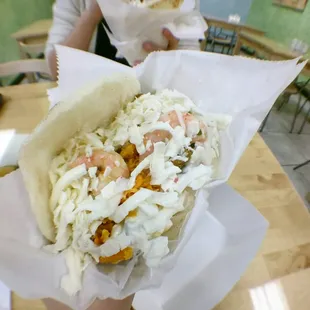 a person holding a sandwich