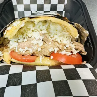 Arepa de Pernil ( Pulled pork caribbean style arepa) with tomato and fresco cheese.