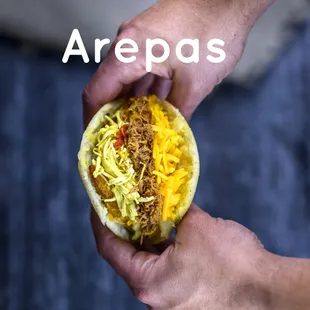 a person holding a taco