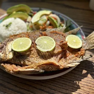 a plate of fish and rice