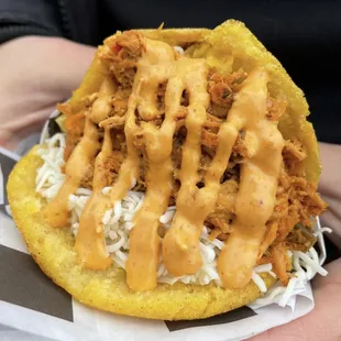 a close up of a person holding a taco