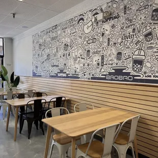 a restaurant with a large mural on the wall