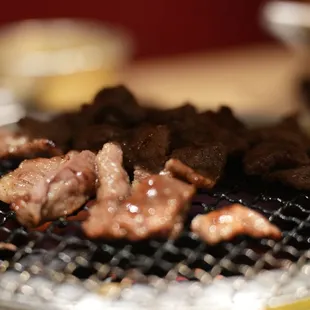 a closeup of meat on a grill