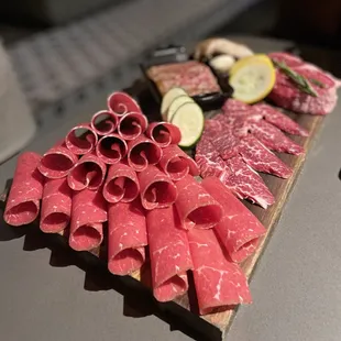 a variety of meats on a cutting board