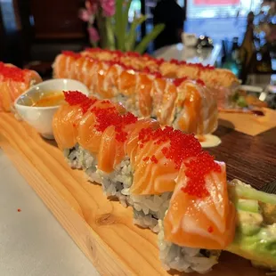 a sushi platter with salmon, avocado, and red cavia