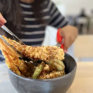 Action cut of the huge portion conger tempura it's fluffy and flaky. Juicy. Different from unagi. Interesting specialty here.