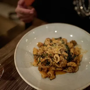 a plate of pasta with spinach and parmesan cheese