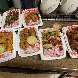 (Top left to bottom) Bulgogi Fries, Glazed Dumplings, Green Sauce, White Sauce, Korean Taco trio, gangjung chicken