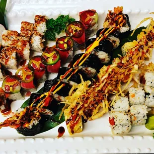 a plate of sushi and vegetables