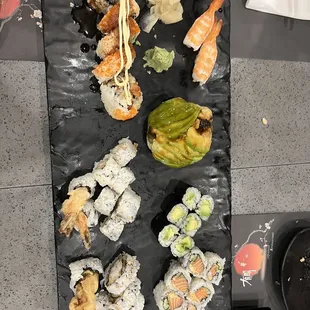 a plate of sushi and rolls
