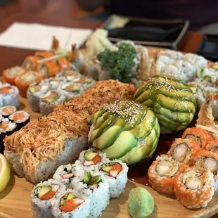a platter of sushi and vegetables