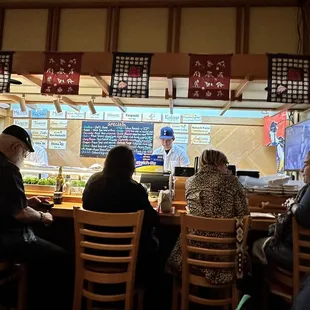 a group of people sitting at a bar