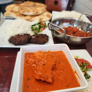 a plate of rice and a bowl of tomato sauce