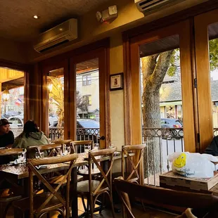 people sitting at tables in a restaurant