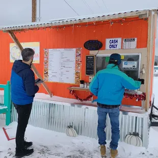 two people standing outside in the snow