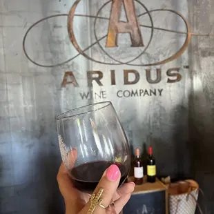 a hand holding a wine glass