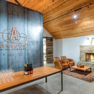 Inside view of tasting room with a comfy seating area to enjoy your glass of wine next to the fireplace.