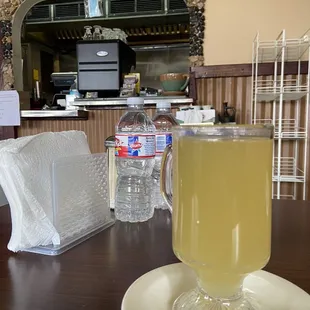 Hot ginger tea with honey. Ginger will clear your throat!