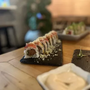 a variety of sushi on a wooden table