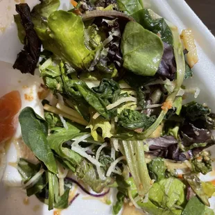 a salad in a styrofoam container
