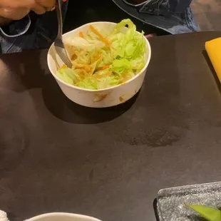a woman eating a bowl of sushi