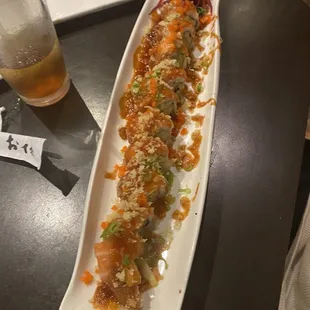a plate of sushi and a glass of beer