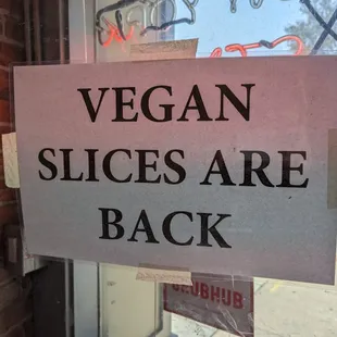 a sign that says vegan slices are back