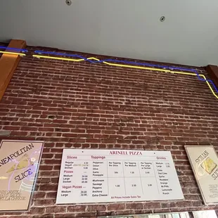 a brick wall with a menu on it