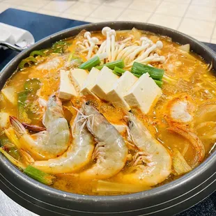 a bowl of soup with shrimp and noodles