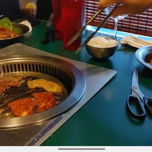Using the grill at the table. The scissors work great and help alot with cooking meat faster.