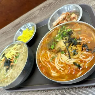 a bowl of ramen and bowls of soup
