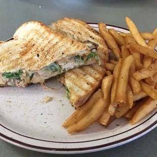 Cajun chicken Panini with fries. (Just a hint, the sauce is extremely spicy so if you don&apos;t do spicy have them put it on the side !)