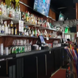 a bar with a lot of bottles and umbrellas