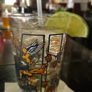 a shot of a drink with a lime wedge