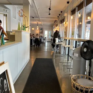 a view of a restaurant with people sitting at tables