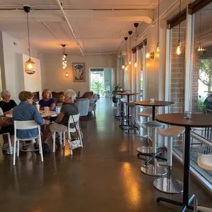a group of people sitting at tables in a restaurant