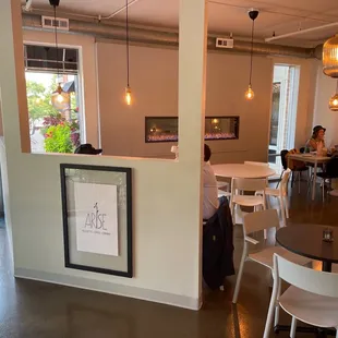 a view of a dining room with tables and chairs