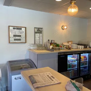 a restaurant counter with a beverage cooler