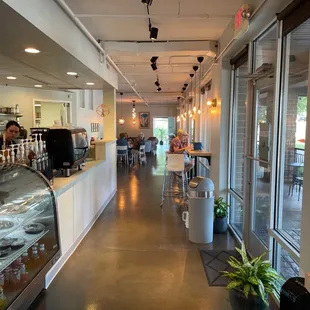 the inside of a restaurant with a counter and a glass case