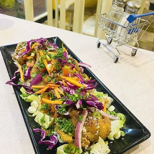 a plate of food on a table with a shopping cart in the background