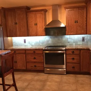Crown molding, staggered elevations/depths on cabinets, farm sink and granite all work to make this kitchen perfect.