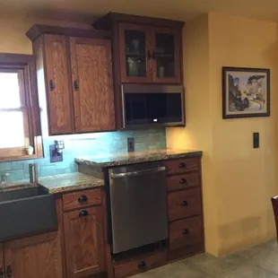 The granite above the raised dishwasher makes a great place to charge phones and such.  There is even a drawer below the dishwasher.