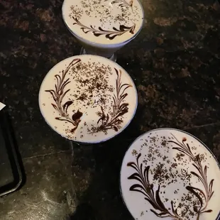 three cocktails with chocolate decorations