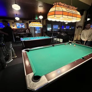 a pool table with a green cloth