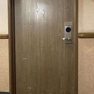 The door to the room looks like crippled zombies tried scratching through into the room. First impression. It's all downhill from here.